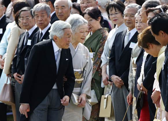 Japan`s Emperor Akihito and Empress Michiko greet guests during a spring garden party at the Akasaka Palace imperial garden in Tokyo.