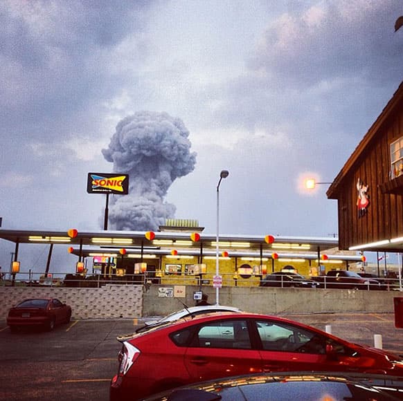 A plume of smoke rises from a fertiliser plant fire in West, Texas. An explosion at a fertiliser plant near Waco Wednesday night injured dozens of people and sent flames shooting high into the night sky, leaving the factory a smoldering ruin and causing major damage to surrounding buildings.