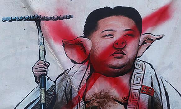 A banner with picture of North Korean leaders Kim Jong-Un is displayed by South Korean protesters during an anti-North Korea protest rally in downtown Seoul, South Korea.
