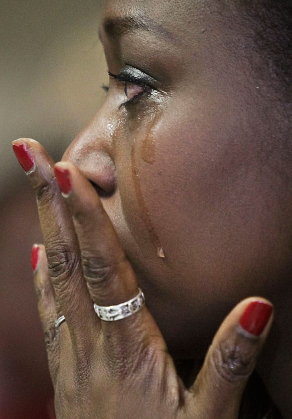Immaculee Ilibagiza wipes away tears as she views a video message from President Obama during the U.S. Citizenship and Immigration Services naturalization ceremony in New York.