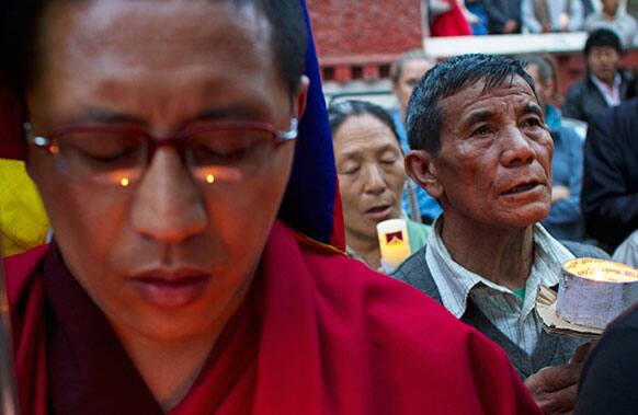 Exile Tibetans hold a candlelit vigil in candlelit vigil in Dharmsala, India, Wednesday, April 17, 2013. Exiles claim that another Tibetan, a 20-year-old woman , died after self-immolating in Eastern Tibet.
