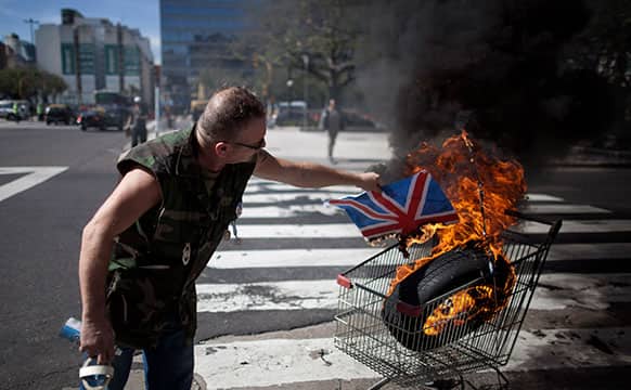 Argentina Falklands War veteran, Marcelo Wytrykusz, burns a Union Jack in protest in Buenos Aires, Argentina.