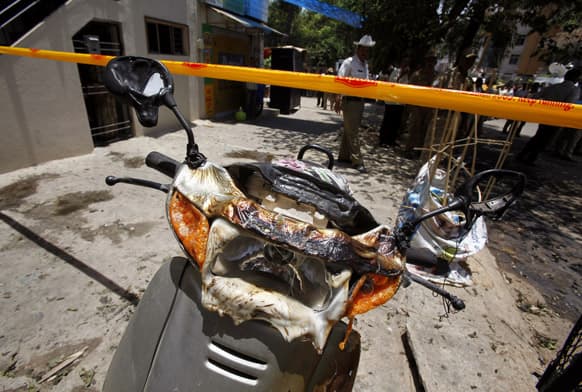 A partly charred scooter stands at the site of an explosion in a residential neighborhood near the office of Bharatiya Janata Party, in Bangalore.