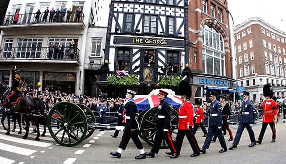 A Union flag draped coffin bearing the body of former British Prime Minister Margaret Thatcher is carried on a gun carriage drawn by the King`s Troop Royal Artillery during her ceremonial funeral procession in London.
