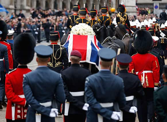 A Union flag draped coffin bearing the body of former British Prime Minister Margaret Thatcher is carried on a gun carriage drawn by the King`s Troop Royal Artillery during her ceremonial funeral procession in London.