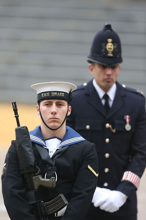 A member of the armed forces stands guard in front of a police officer during the funeral of former British Prime Minister Margaret Thatcher at St Paul`s Cathedral in London.