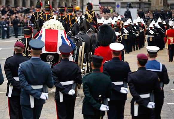 A Union flag draped coffin bearing the body of former British Prime Minister Margaret Thatcher is carried on a gun carriage drawn by the King`s Troop Royal Artillery during her ceremonial funeral procession in London.