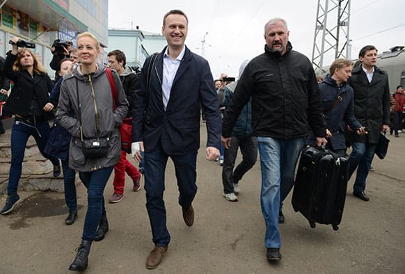 Russian opposition leader Alexei Navalny, centre, walks with his supporters as he arrives to attend a trial in Kirov, Russia.