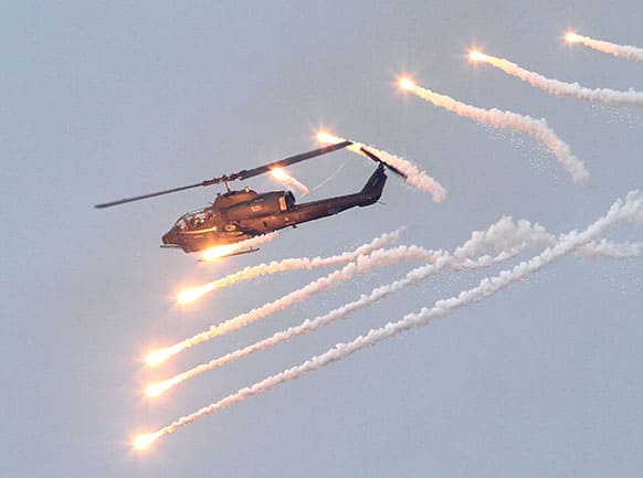 An AH-1W Attack Helicopter launches flares during Han Kuang military exercises in Penghu county, Taiwan.