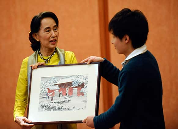 Myanmar opposition leader and Nobel Peace Prize laureate Aung San Suu Kyi receives a gift after her lecture at the University of Tokyo.