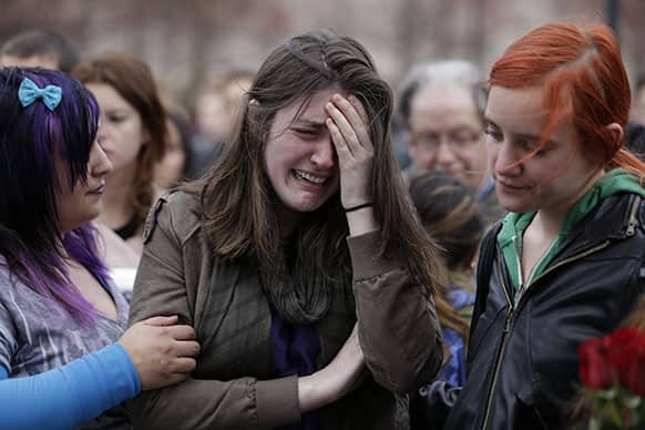 Emma MacDonald, 21, center, cries during a vigil for the victims of the Boston Marathon explosions at Boston Common.
