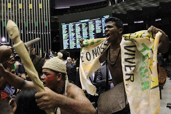 Indians from various tribes protest inside the lower house of Congress against a proposed amendment that would give Congress a say in the demarcation of indigenous territory, in Brasilia, Brazil.