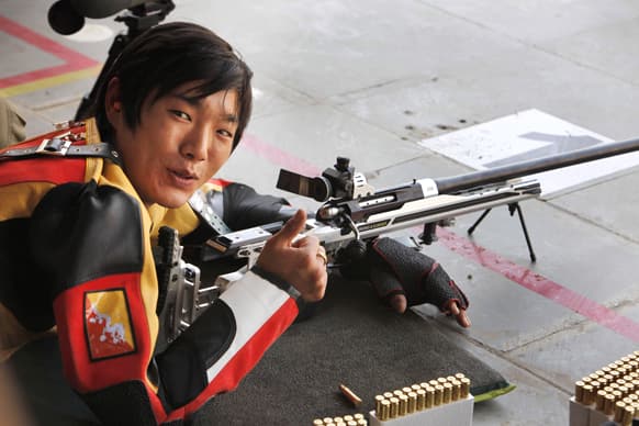 Bhutan’s Prince Jigyel Ugyen Wangchuck gestures to the media as he practices at the national shooting championship in Hyderabad. Wangchuck is expected to participate in the 300 meters big bore event Wednesday.
