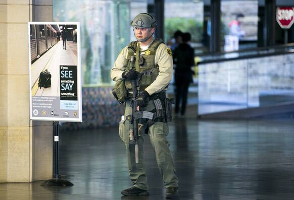 A Los Angeles Sheriffs Counter Terrorism Unit officer carries an AR-15 assault rifle, as he patrols the entrance to Union Station in Los Angeles.