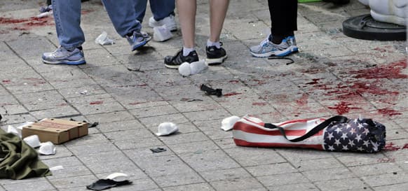 Blood from victims covers the sidewalk on Boylston Street, at the site of an explosion during the 2013 Boston Marathon in Boston.