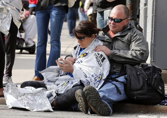 Chris Darmody, right, holds his wife Sue in Boston. Chris says he was waiting for Sue when an explosion detonated near his location at the finish line of the Boston Marathon.