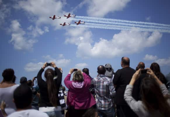 People take a photographs during Independence Day in Tel Aviv. Israel is celebrating its annual Independence Day, marking 65 years since the founding of the state in 1948.