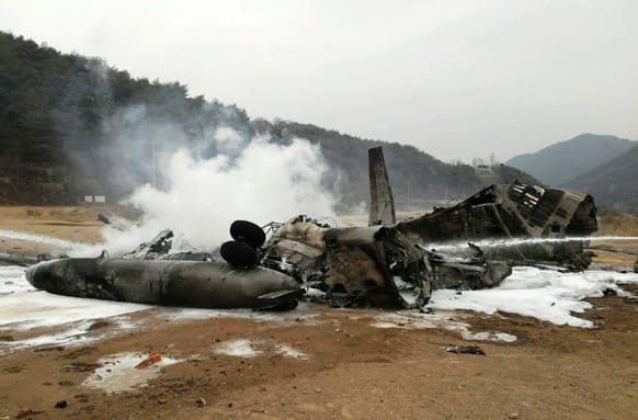 The wreckage of a US Marine helicopter CH-53E Super Stallion helicopter smolders after it made a