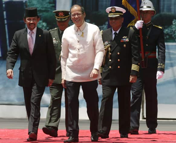 Visiting Sultan Hassanal Bolkiah of Brunei, is escorted by Philippine President Benigno Aquino III, on the grounds of Malacanang Palace, in Manila, Philippines.