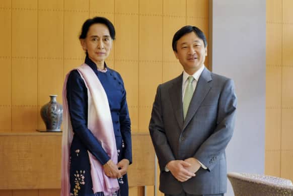 Nobel laureate and Myanmar opposition leader Aung San Suu Kyi, left, and Japanese Crown Prince Naruhito pose for photographers during their meeting at the latter`s residence Togu Palace in Tokyo.