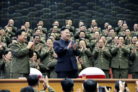 North Korean leader Kim Jong Un applauds as he visits an athletics contest held by Kim Il Sung University of Politics and Kim Il Sung Military University, at a stadium in North Korea.