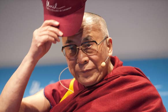 Tibetan spiritual leader Dalai Lama puts a cap on, during an event at the UNIL, University of Lausanne, Switzerland. The Dalai Lama pays a four day visit to Switzerland.