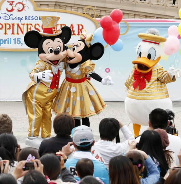 Mickey Mouse, Minnie Mouse and Donald Duck entertain visitors in front of Cinderella Castle during a special performance to celebrate the 30th anniversary of the opening of Tokyo Disneyland in Urayasu, east of Tokyo.
