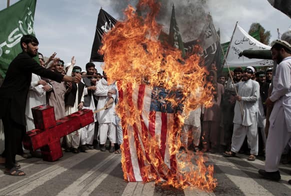 Afghans burn a U.S. flag during a demonstration in Jalalabad, Afghanistan, condemning last week`s air strike in Kunar.