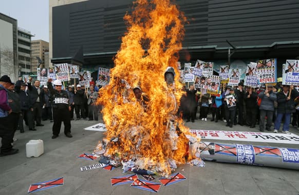 South Korean protesters burn effigies of North Korean leader Kim Jong-Un, and late leaders Kim Jong Il and Kim Il Sung at an anti-North Korea protest on the birthday of Kim Il Sung in Seoul, South Korea.