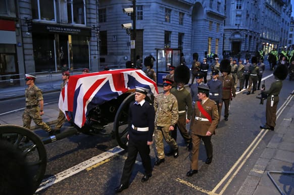 British forces` officers escort a Union Jack-draped coffin on a gun carriage drawn by the King`s Troop Royal Artillery during a rehearsal for the upcoming funeral of former British Prime Minister Margaret Thatcher in central London.