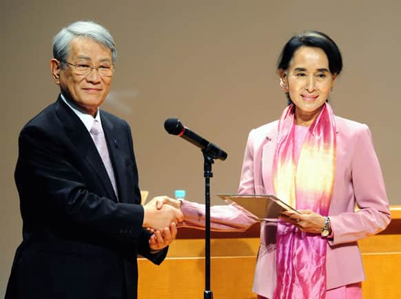 Nobel laureate and Myanmar opposition leader Aung San Suu Kyi, receives a title of honorary fellow from President of Kyoto University Hiroshi Matsumoto at Kyoto University where she studied nearly three decades ago, in Kyoto.