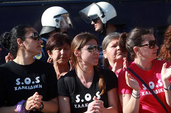Protesters wearing shirts that read