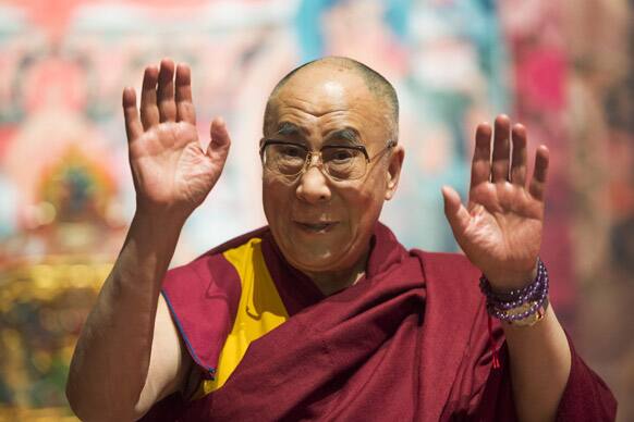Tibetan spiritual leader Dalai Lama gestures during a spiritual event at the Forum Arena in Fribourg, western Switzerland. The Dalai Lama pays a four day visit to Switzerland.