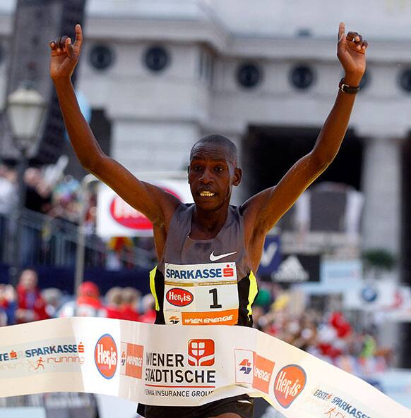 Henry Sugut of Kenya crosses the finish line to win the Vienna city marathon, in Vienna Austria.