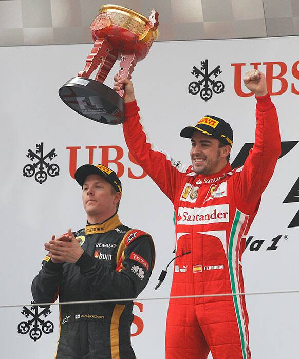 Ferrari driver Fernando Alonso of Spain celebrates on the podium after winning the Chinese Formula One Grand Prix in Shanghai.