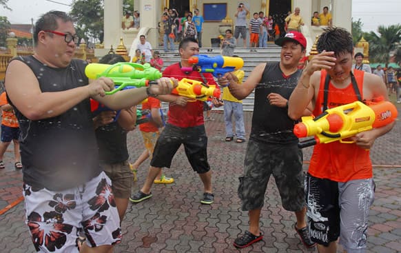 People shoot each other with water guns as they celebrate the Songkran festival, the Thai traditional New Year, also known as the water festival in Petaling Jaya, near Kuala Lumpur, Malaysia.