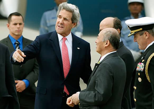 US Secretary of Sate John Kerry is greeted by an unidentified Japanese Foreign Ministry official upon his arrival at Haneda International Airport in Tokyo.
