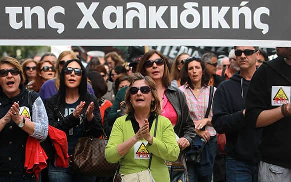 supporting a campaign to block a gold mine development in northern Greece, shout slogans during a protest march against Canadian mining firm Eldorado Gold Corp.