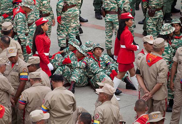 Members of the Bolivarian Militias wait for the start of a ceremony marking its` namesake day in Caracas.