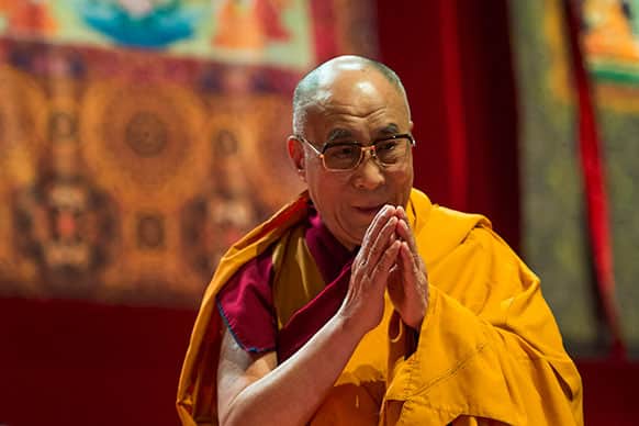 Tibetan spiritual leader Dalai Lama gestures during a spiritual event at the Forum Arena in Fribourg, western Switzerland.