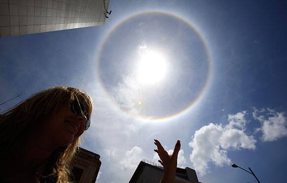 The sun and atmospheric conditions combine to create a rainbow colored ring around the sun, known as a solar halo, in the skies above Havana, Cuba.