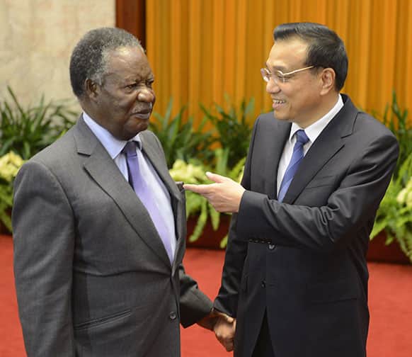 Chinese Premier Li Keqiang, right, chats with Zambia`s President Michael Sata before a meeting at the Great Hall of the People in Beijing.