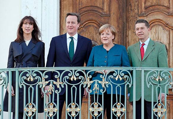 German Chancellor Angela Merkel and her husband Joachim Sauer , right, welcome Britain`s Prime Minister David Cameron and his wife Samantha, left, at the government`s guest house Schloss Meseberg, 70 km (44 miles) north of Berlin.
