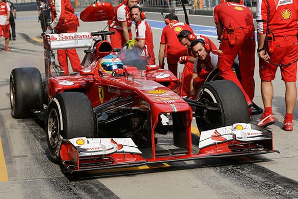 Ferrari driver Fernando Alonso of Spain steers his car out of pit lane after a tire change during the second practice session for the Chinese Formula One Grand Prix in Shanghai.