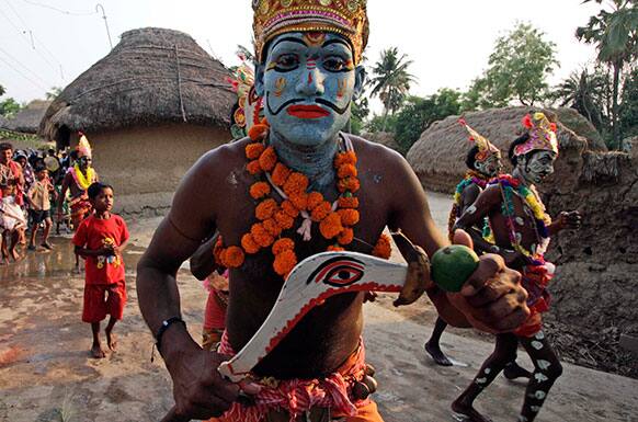 Hindu devotees participate in a procession during Shiva Gajan Hindu festival celebrations in Kurmun, about 120 kilometers (75 miles) from Kolkata.
