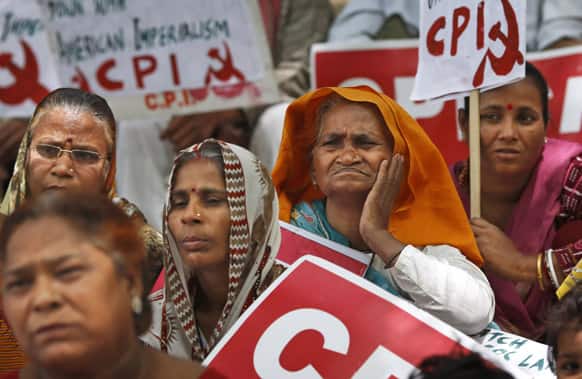 Supporters of the Communist Party of India (CPI) watch during a protest rally in New Delhi. The protest was against the alleged harassment of villagers to hand over their land for a proposed steel plant to South Korean conglomerate POSCO in Orissa.