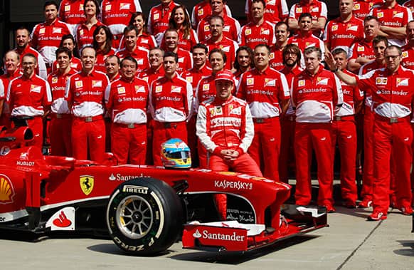 Ferrari drivers Fernando Alonso of Spain poses with his team for a group photo prior to the first practice session at the Chinese Formula One Grand Prix in Shanghai.