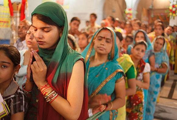 Indian devotees stand in queue to offer prayers at a Hindu temple on the second day of `Navratri` or the nine nights festival in Allahabad.