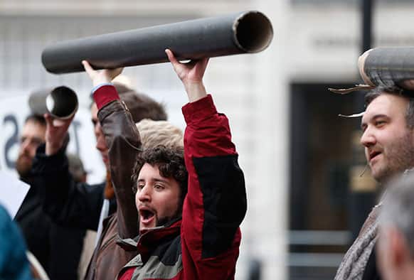 Protesters hold mock-ups of pipes during a demonstration near the G8 foreign ministers’ meeting in central London.