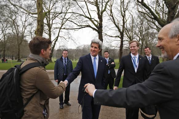 US Secretary of State John Kerry, surrounded by aides and security detail talks to a tourist as he takes a walk at the Green Park in central London, adjacent to the venue where the G8 foreign ministers’ meeting was taking place.